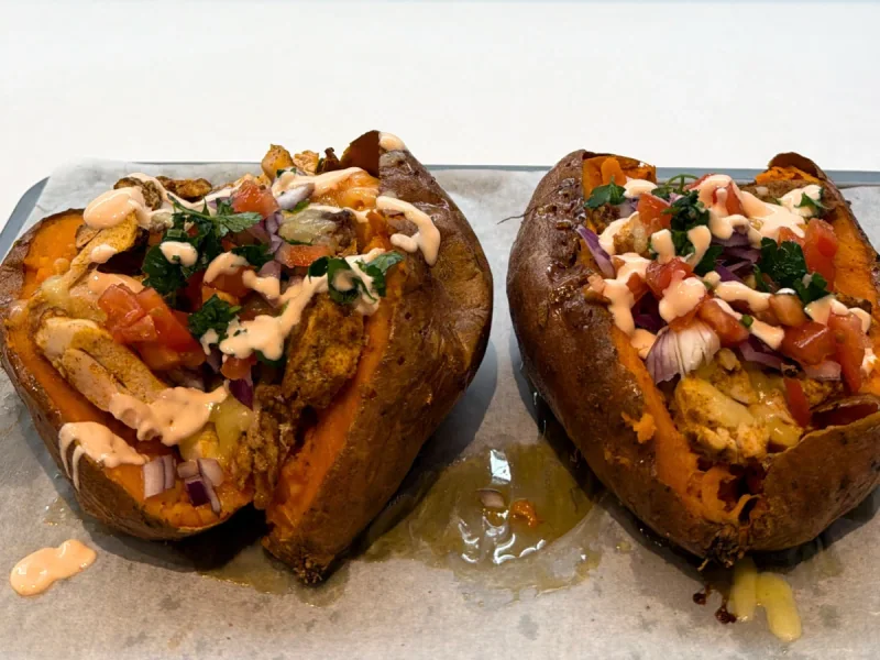 Sweet potatoes filled with shawarma, vegetables and sauce